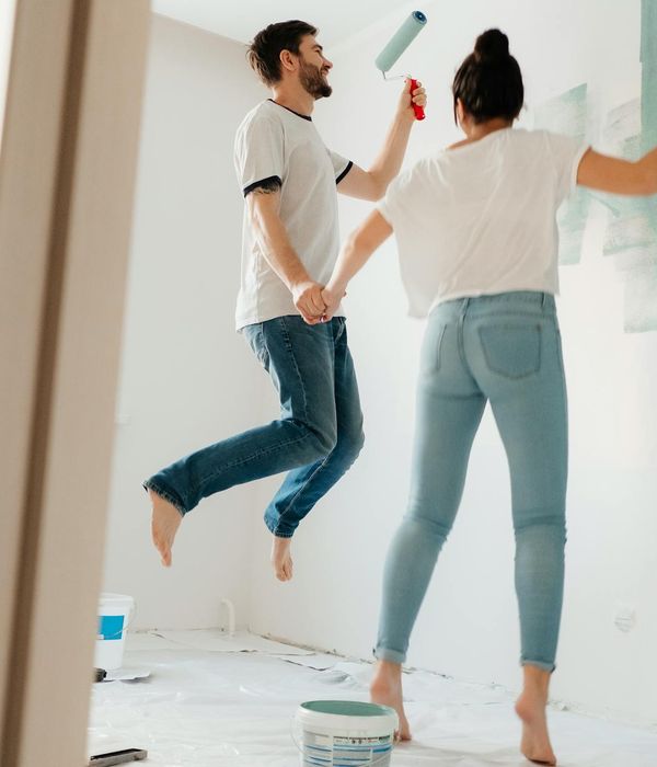 Woman feeling energetic and happy in a bright living room.